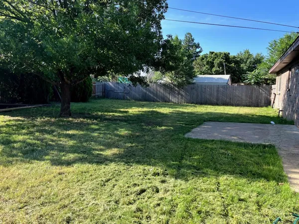a backyard of a house with lots of green space