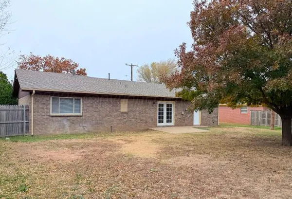 a house that has a tree in front of it