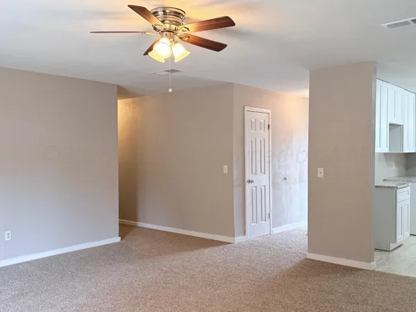 a view of an empty room with a fan