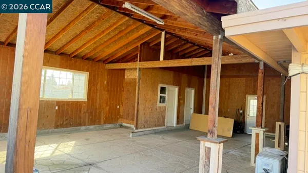 a view of a room with wooden floor and windows