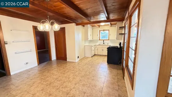 a view of a storage & utility room with refrigerator and windows