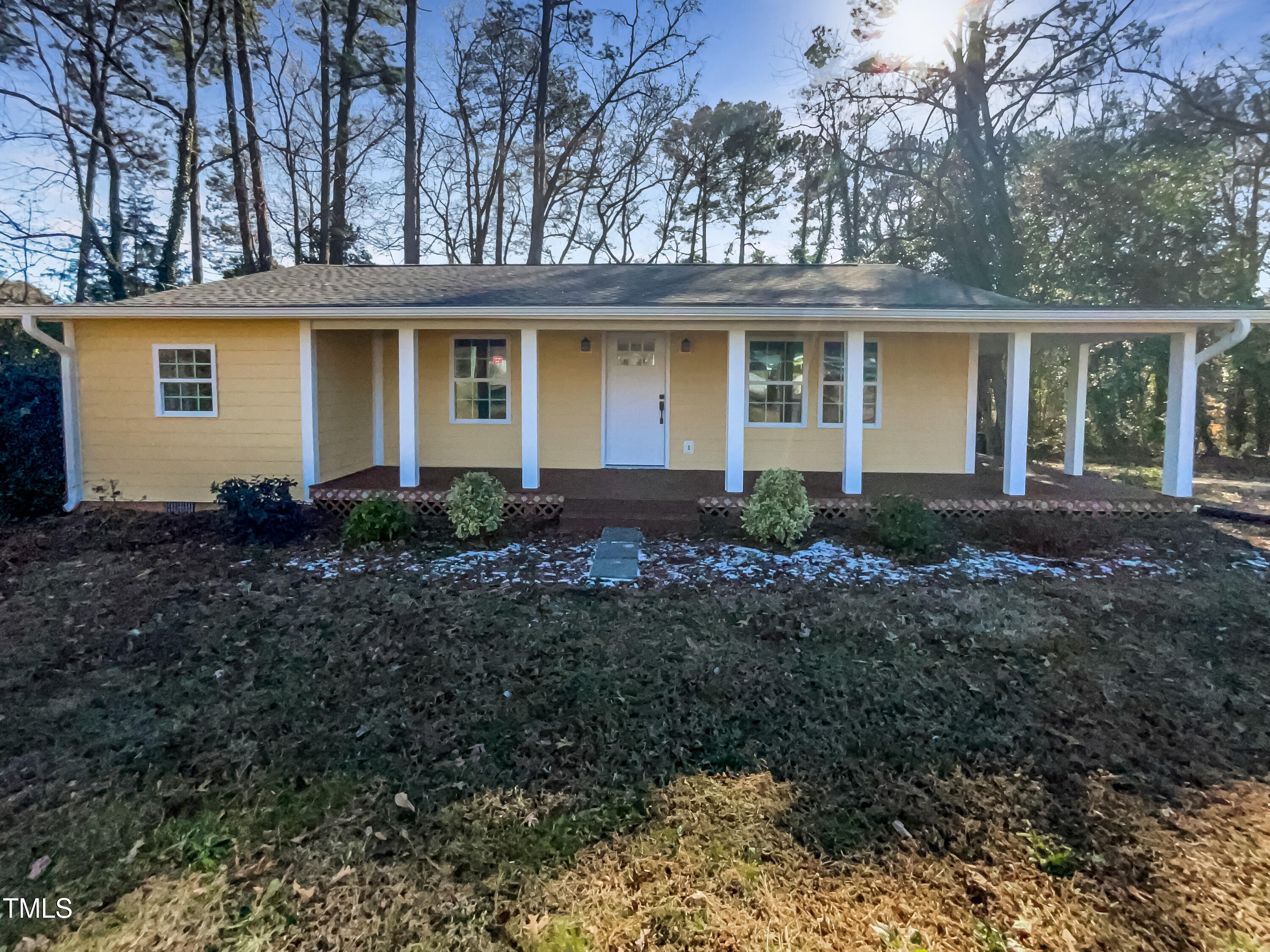 6307 Tryon Road Cary, NC 27518 - Photo 1 of 18 a front view of a house with garden