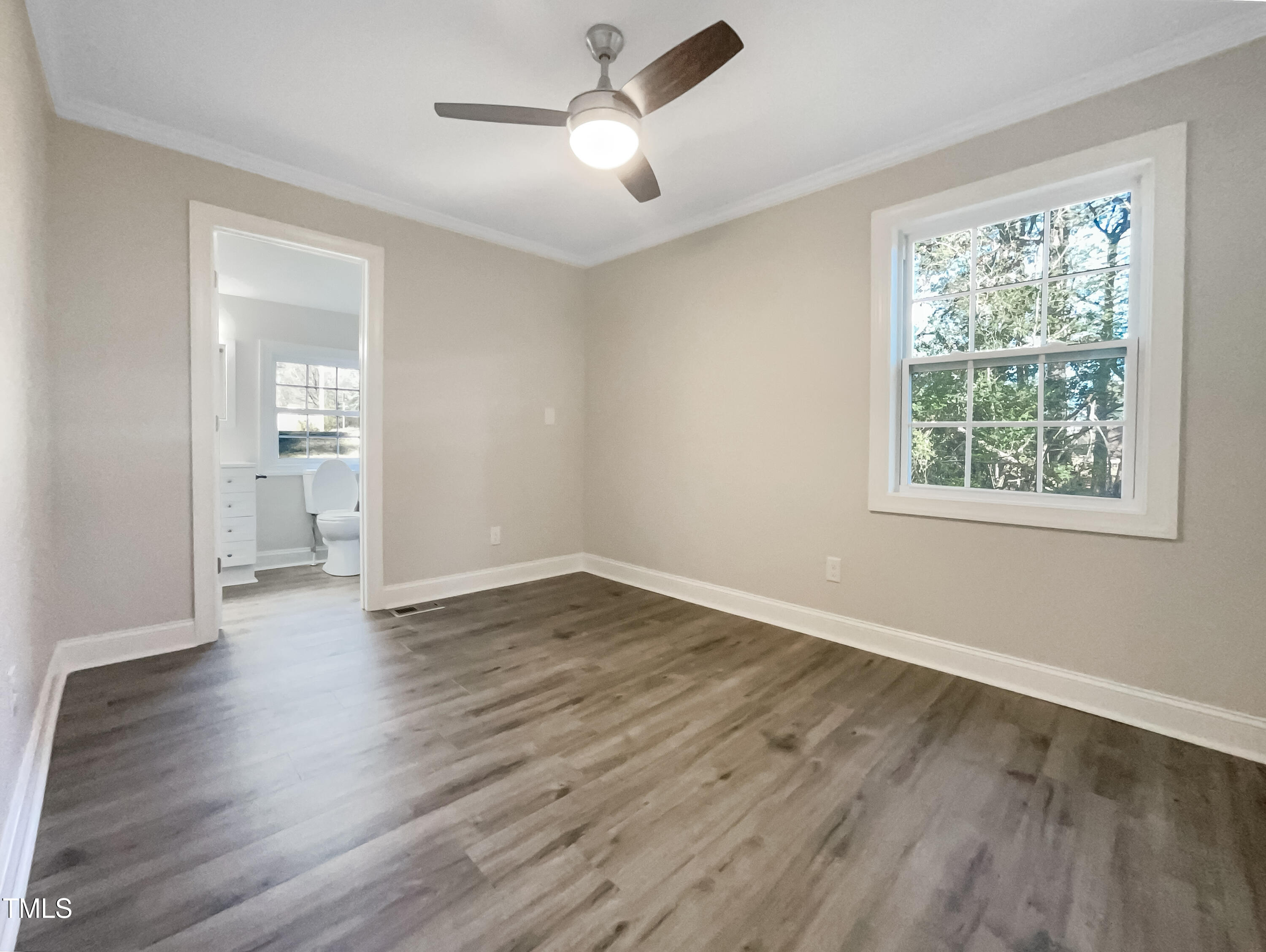 6307 Tryon Road Cary, NC 27518 - Photo 11 of 18 a view of empty room with wooden floor and fan
