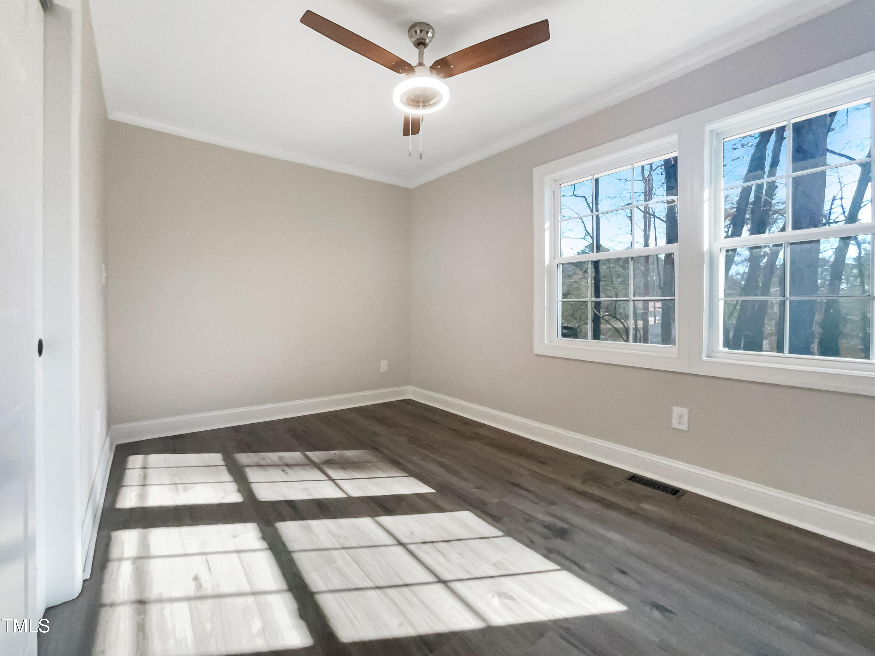 6307 Tryon Road Cary, NC 27518 - Photo 12 of 18 a view of empty room with wooden floor and fan