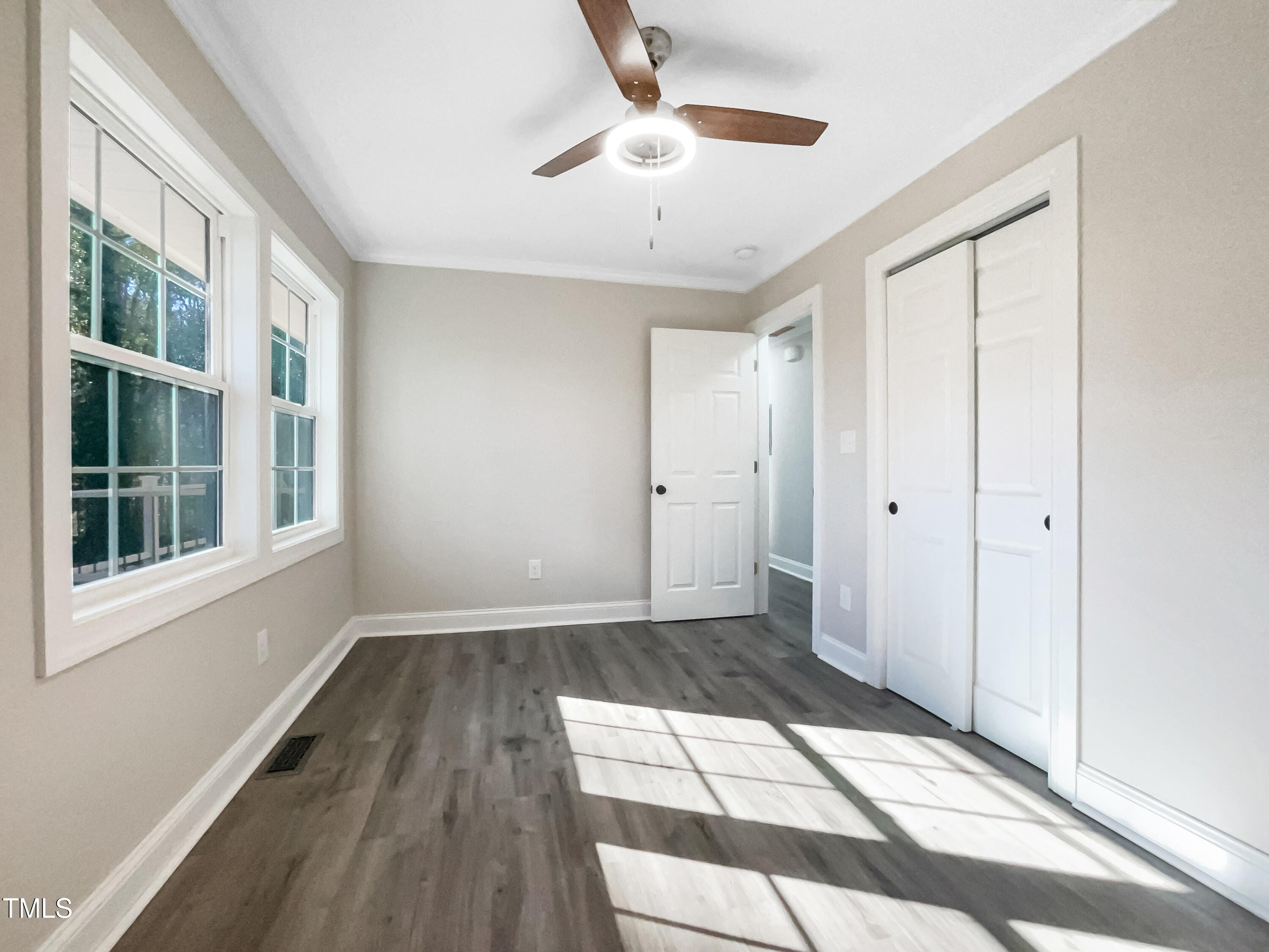 6307 Tryon Road Cary, NC 27518 - Photo 13 of 18 a view of empty room with wooden floor and fan