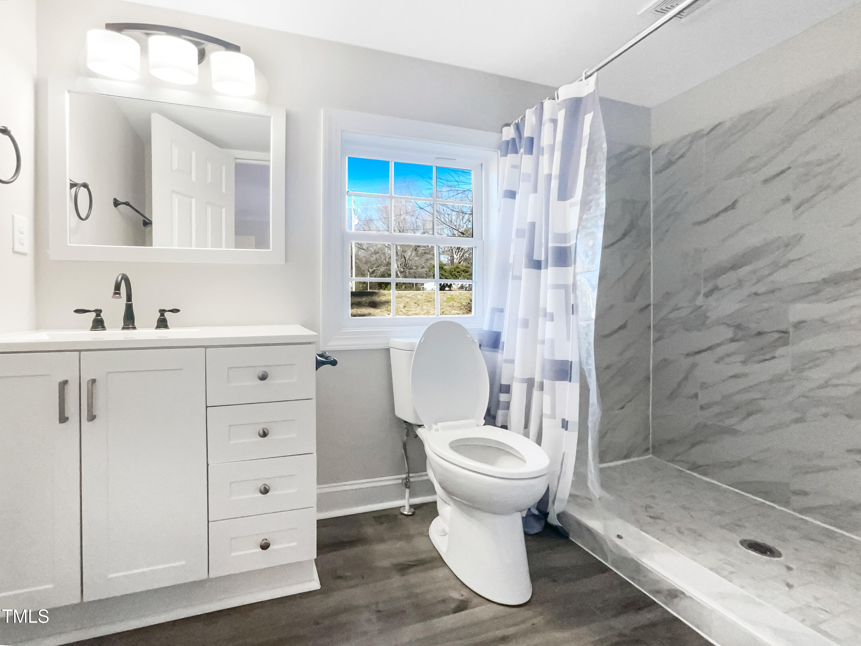 6307 Tryon Road Cary, NC 27518 - Photo 16 of 18 a bathroom with a sink toilet and shower