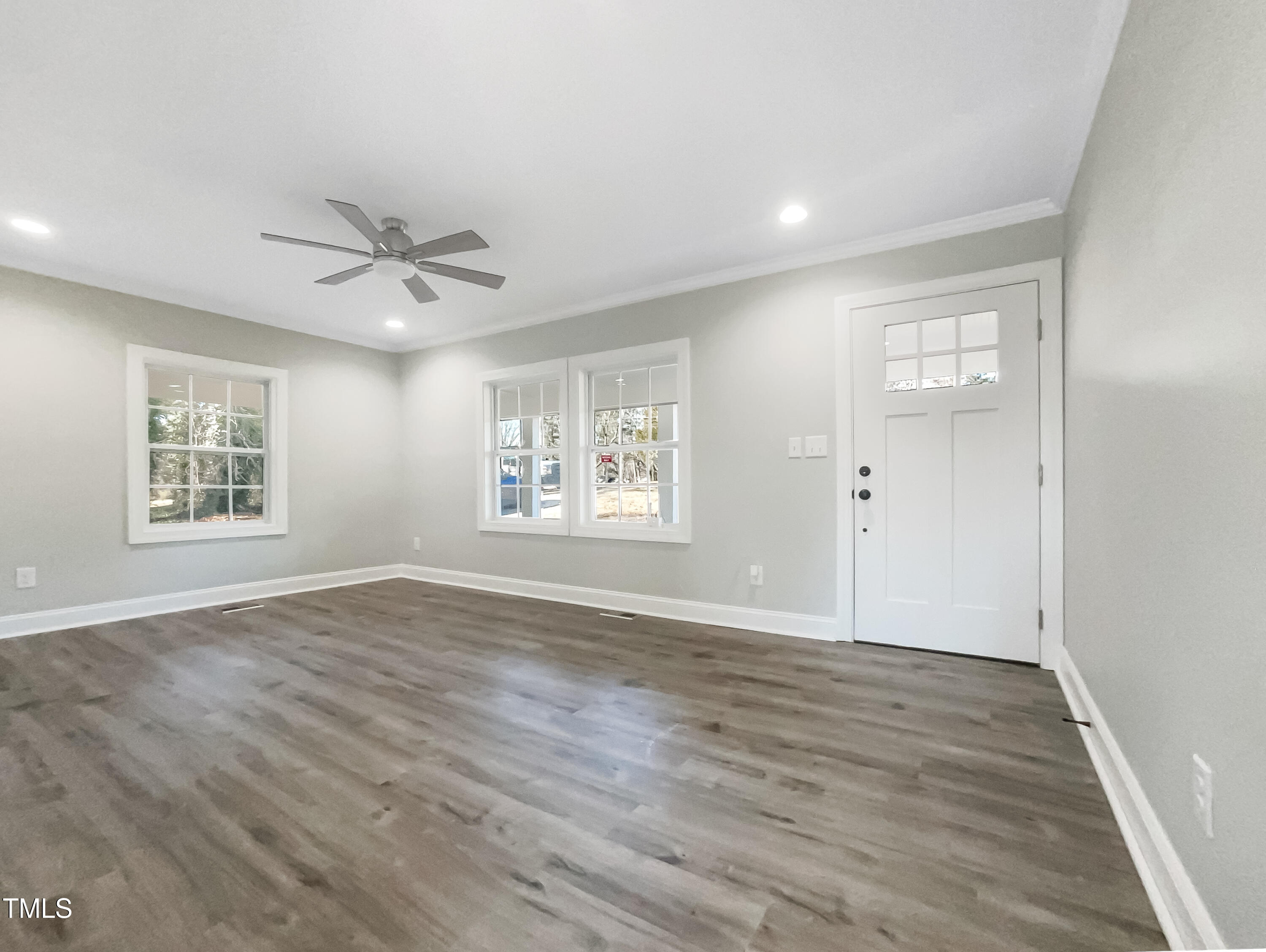 6307 Tryon Road Cary, NC 27518 - Photo 3 of 18 an empty room with wooden floor and windows