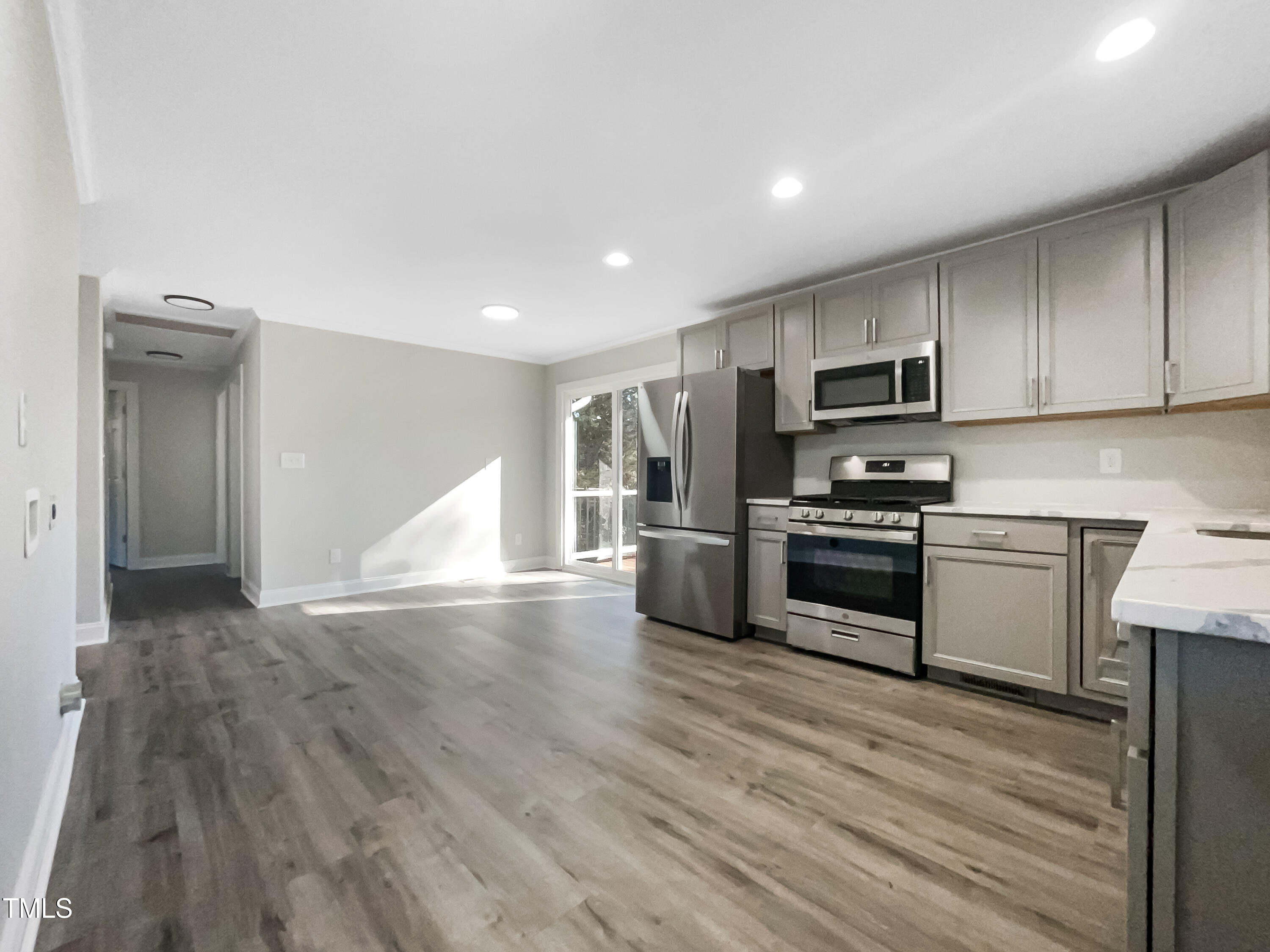 6307 Tryon Road Cary, NC 27518 - Photo 9 of 18 a kitchen with stainless steel appliances a refrigerator and a stove top oven