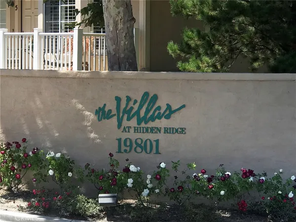 a sign that is sitting in front of a house