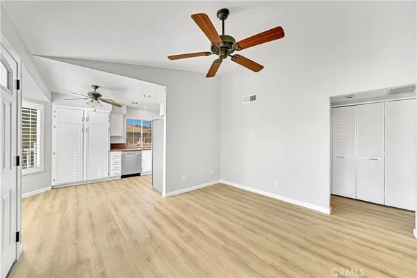 a view of empty room with wooden floor and window