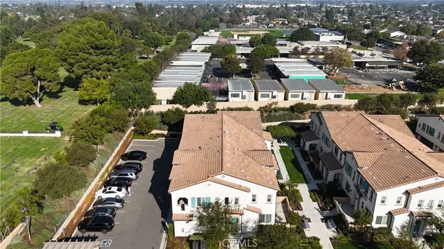 an aerial view of residential houses with outdoor space