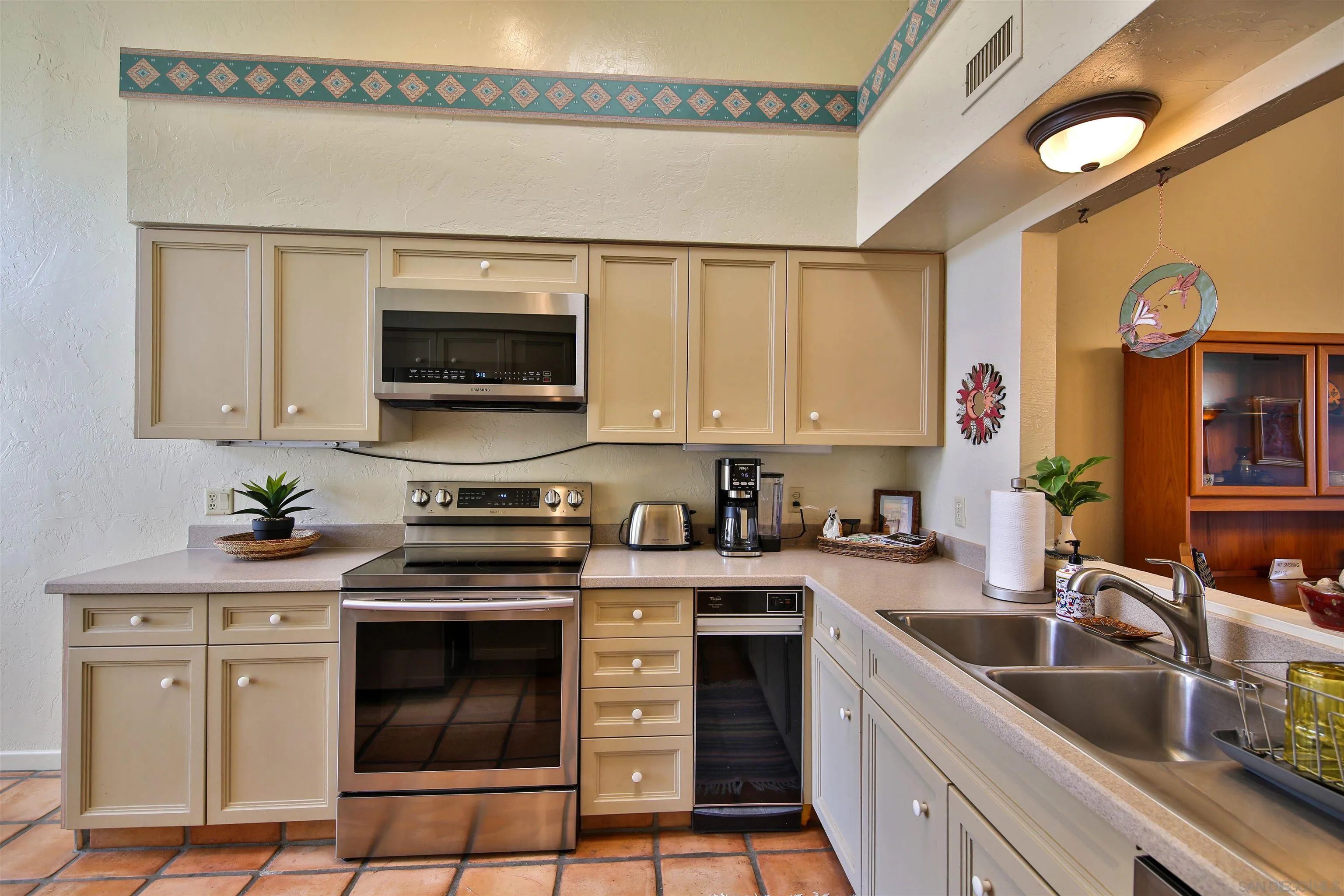 1921 Desert Vista Terrace Borrego Springs, CA 92004 - Photo 6 of 19 a kitchen with stainless steel appliances granite countertop a stove a sink and a microwave
