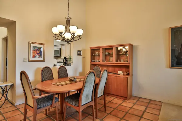 a dining room filled chandelier and wooden floor