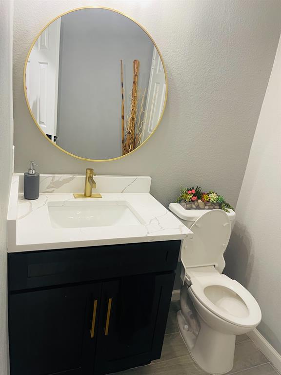 516 Angela Lane Euless, TX 76039 - Photo 16 of 39 Half bathroom with a textured wall and vanity