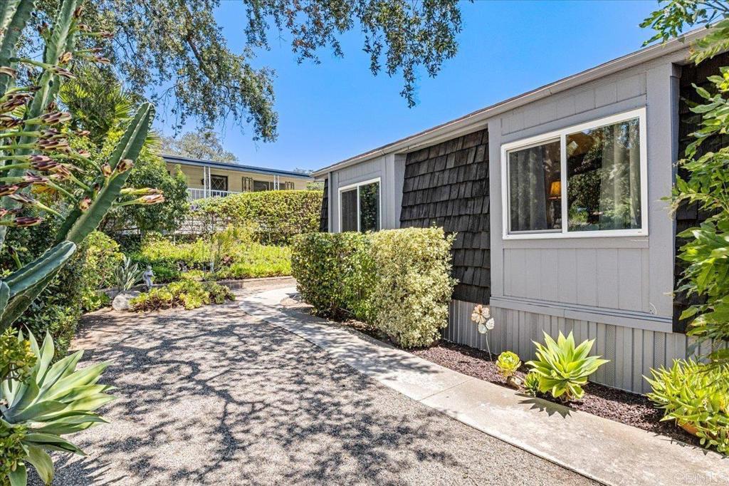 18218 Paradise Mountain Road, Unit 116 Valley Center, CA 92082 - Photo 26 of 35 a view of a house with a flower garden
