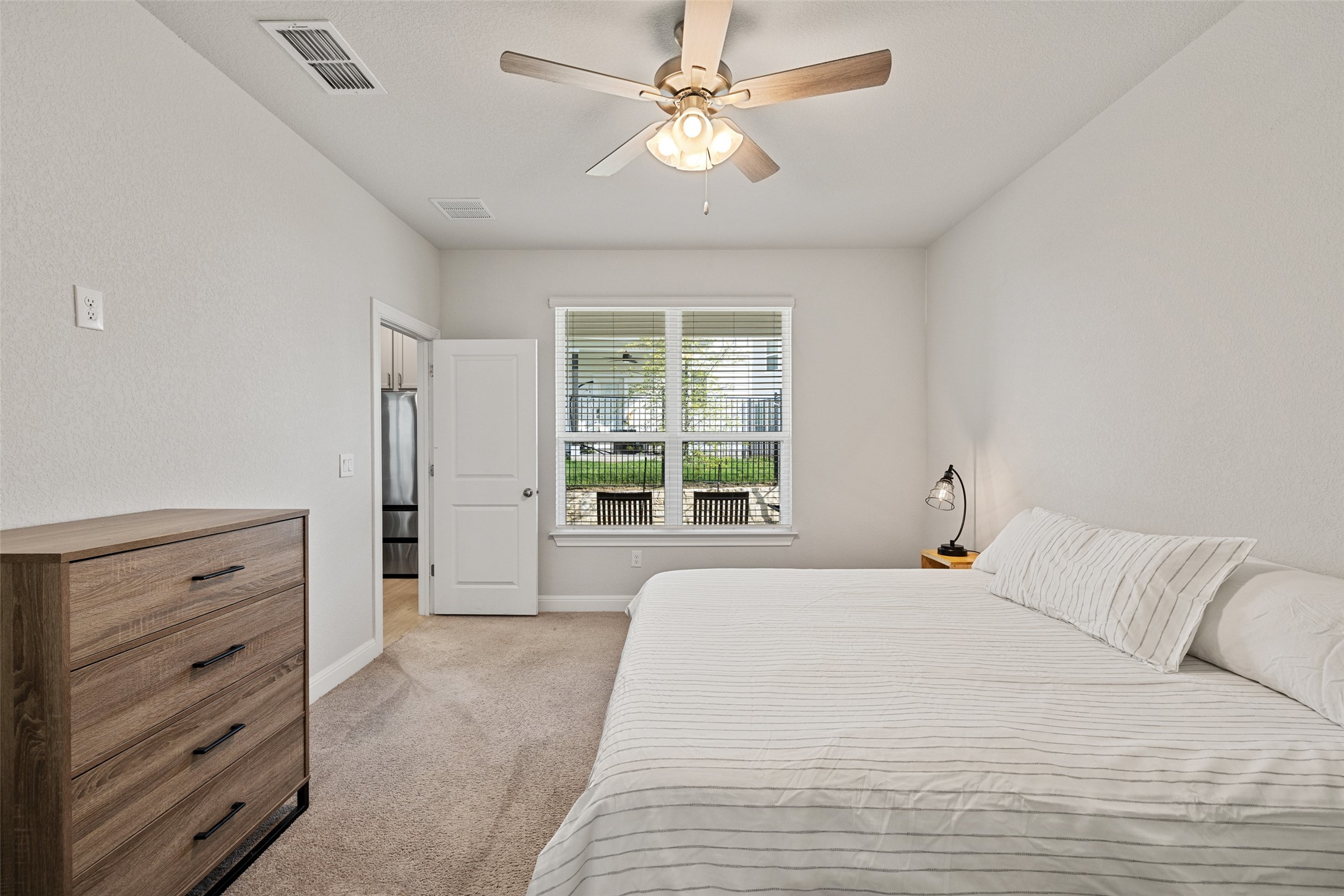 1012 Legend Milton Lane Austin, TX 78748 - Photo 12 of 30 a bedroom with a large bed and a dresser