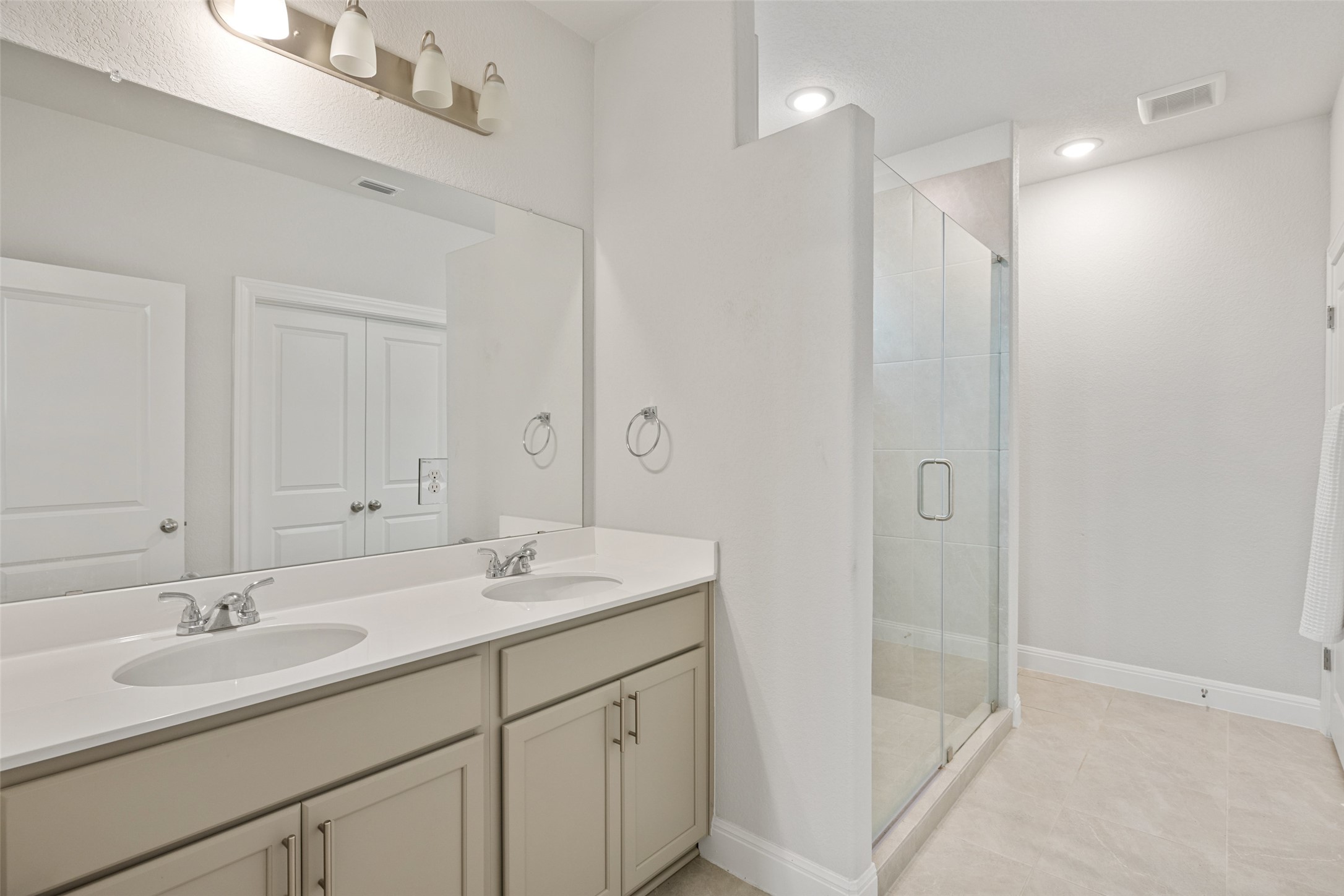 1012 Legend Milton Lane Austin, TX 78748 - Photo 14 of 30 a bathroom with a shower sink vanity and mirror