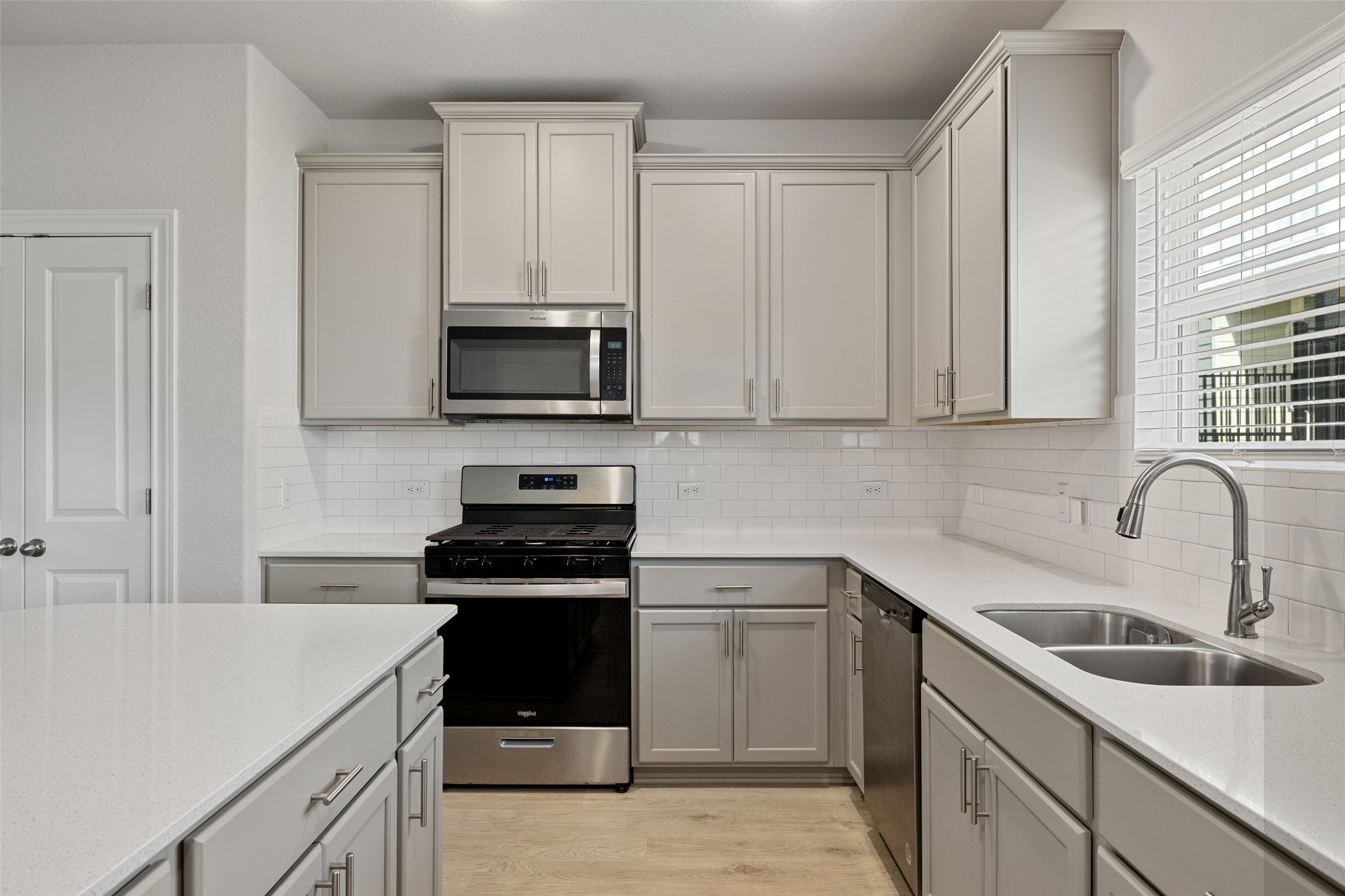 1012 Legend Milton Lane Austin, TX 78748 - Photo 7 of 30 a kitchen with white cabinets stainless steel appliances and sink