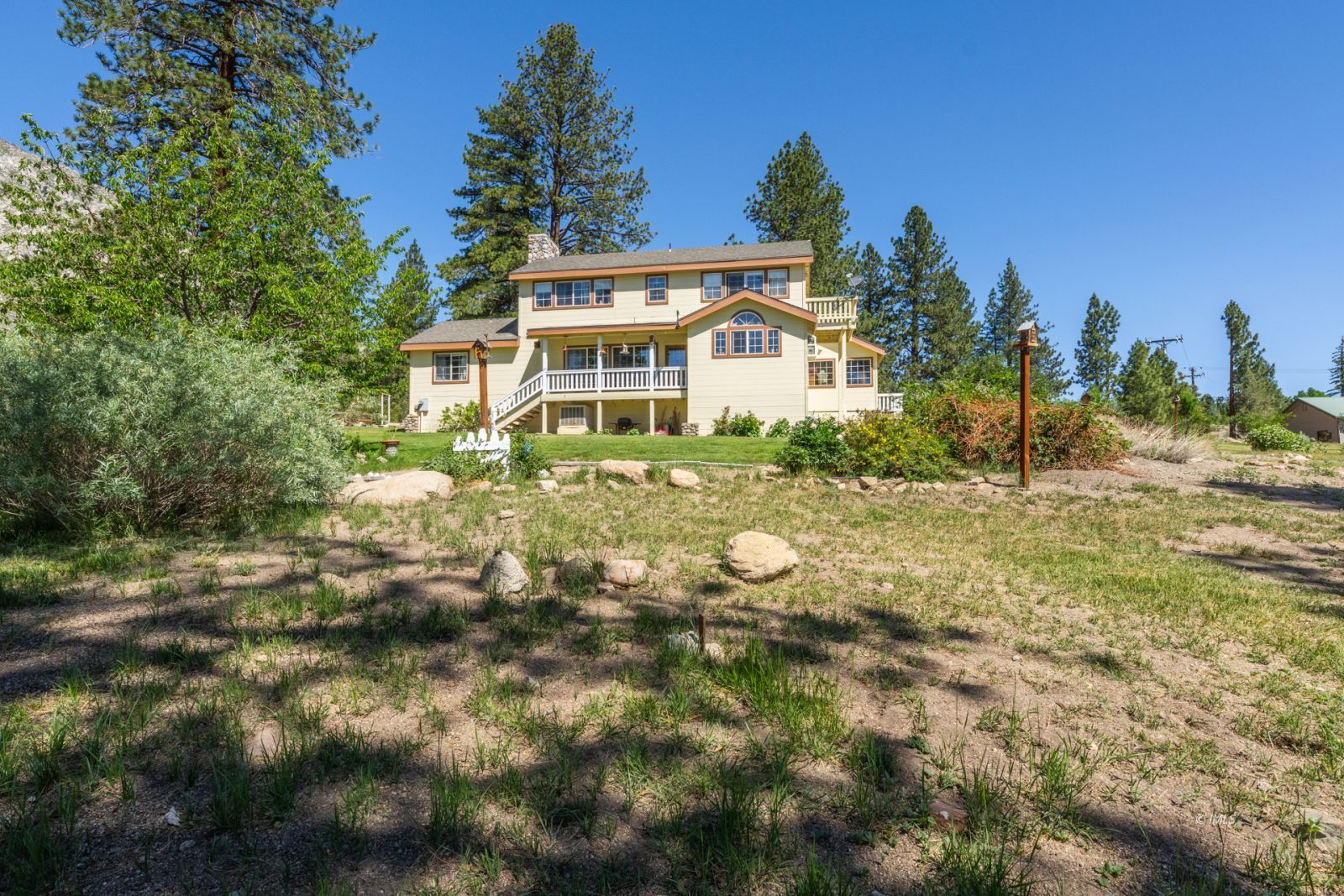 67 Willow Road Swall Meadows, CA 93514 - Photo 2 of 35 a front view of a house with a yard