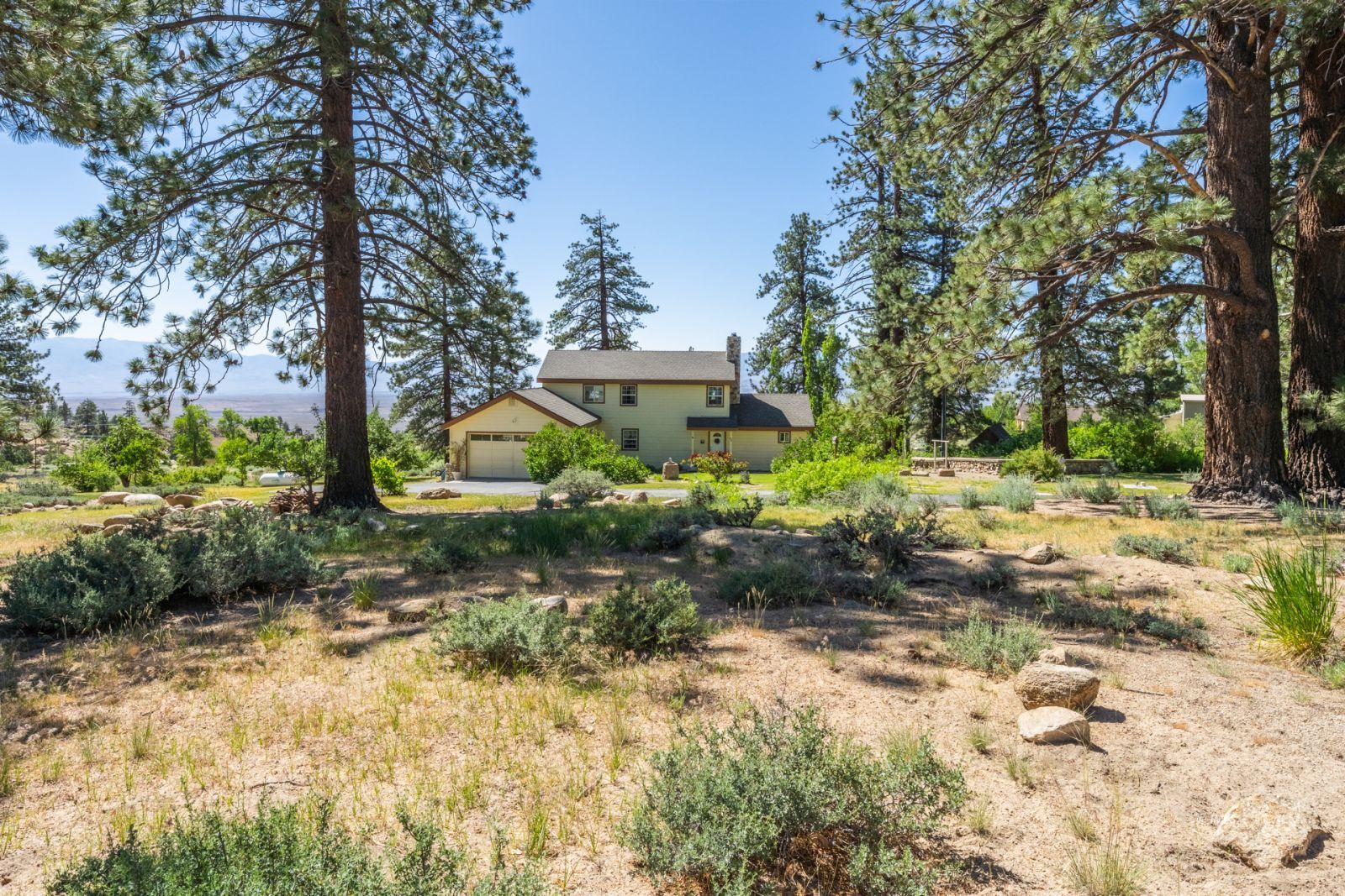 67 Willow Road Swall Meadows, CA 93514 - Photo 35 of 35 a backyard of a house with a garden and outdoor seating