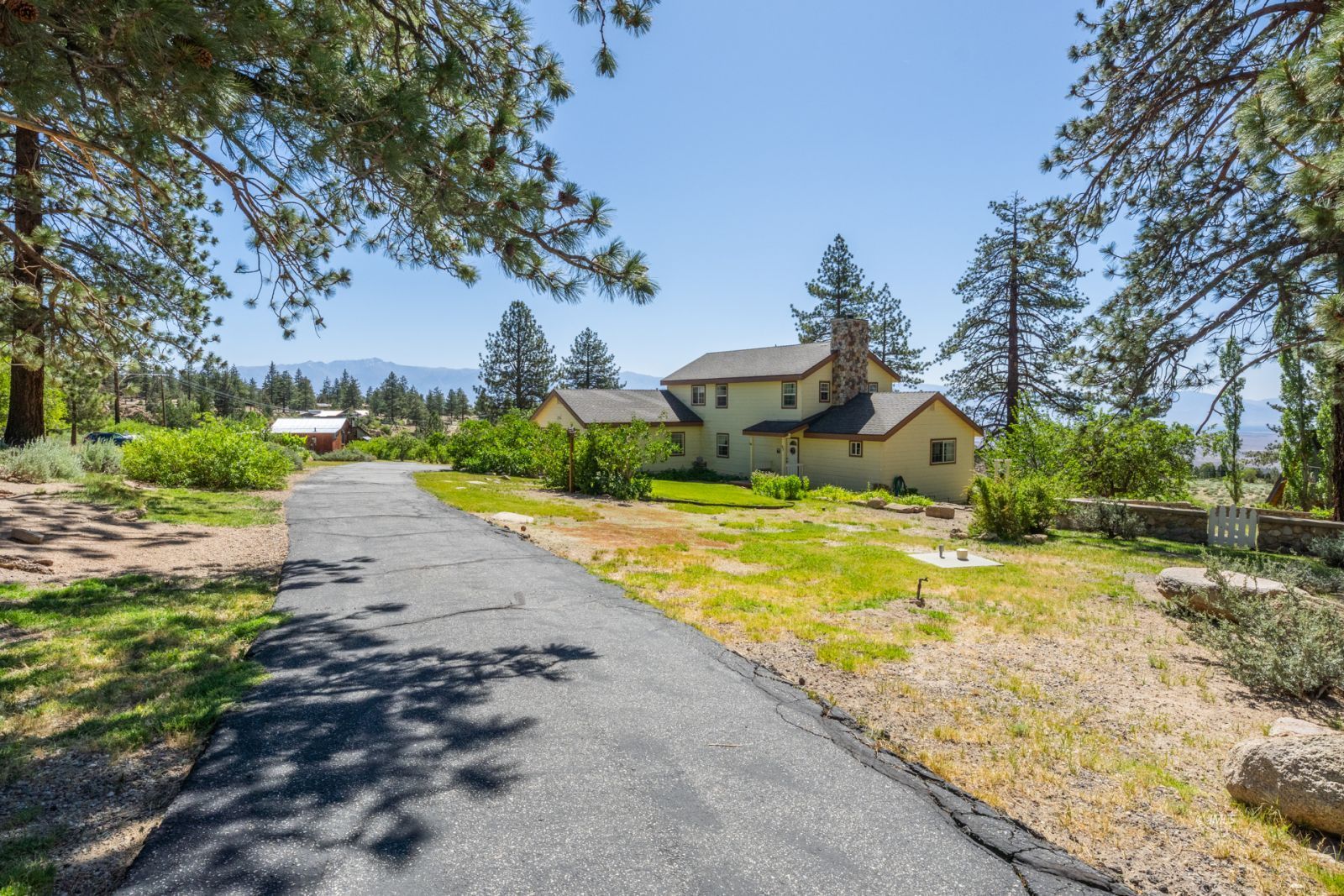 67 Willow Road Swall Meadows, CA 93514 - Photo 5 of 35 a yellow house with trees in front of it