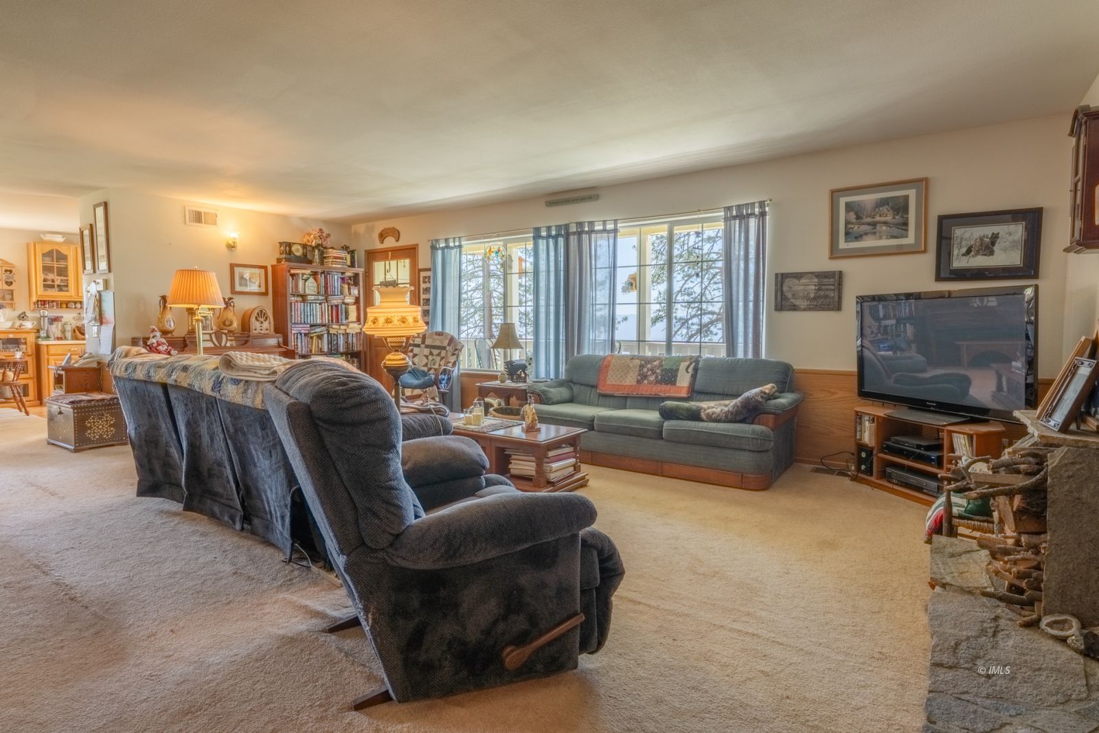 67 Willow Road Swall Meadows, CA 93514 - Photo 10 of 35 a living room with furniture a flat screen tv and a floor to ceiling window