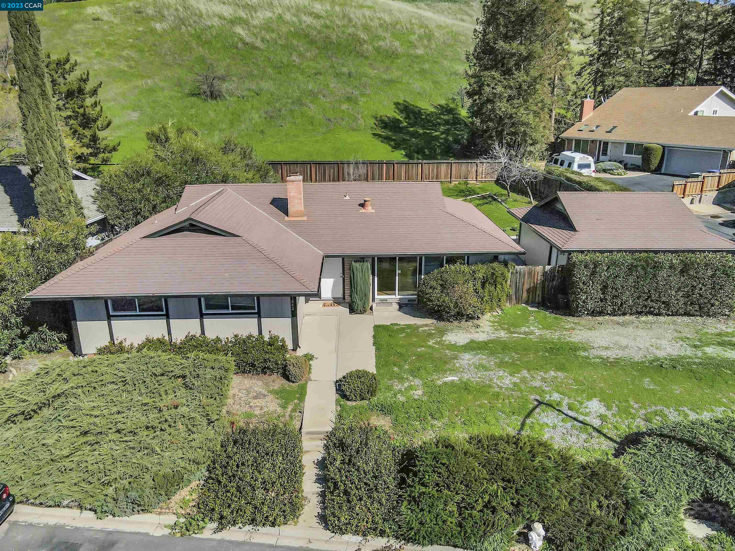 an aerial view of a house with yard and green space