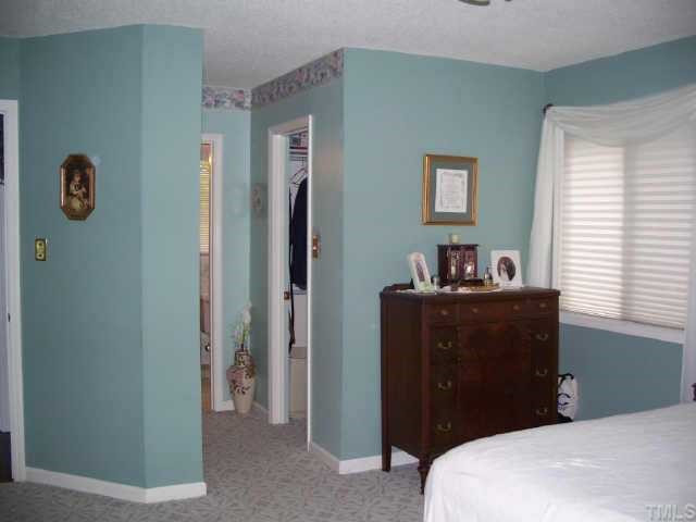 6624 Coach Light Circle Raleigh, NC 27613 - Photo 3 of 10 Spacious Master Bedroom has two walk-in closets and a dressing area with single vanity. Overlooks rear yard and woods beyond. Other