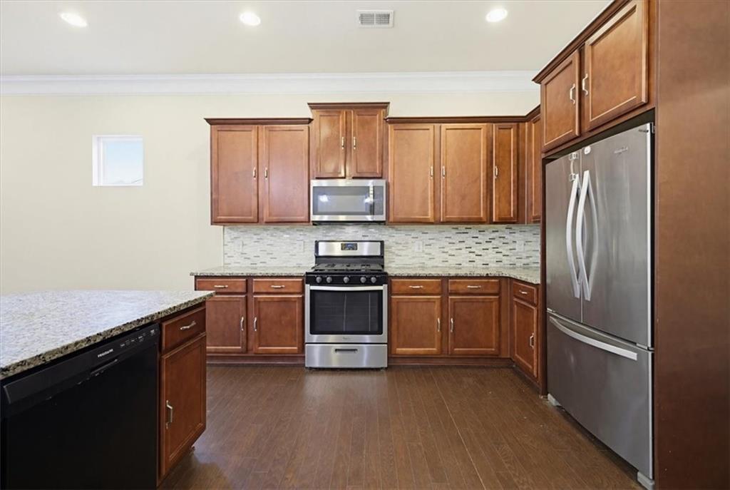 314 Boulder Run Hiram, GA 30141 - Photo 8 of 31 a kitchen with granite countertop a refrigerator stove and sink