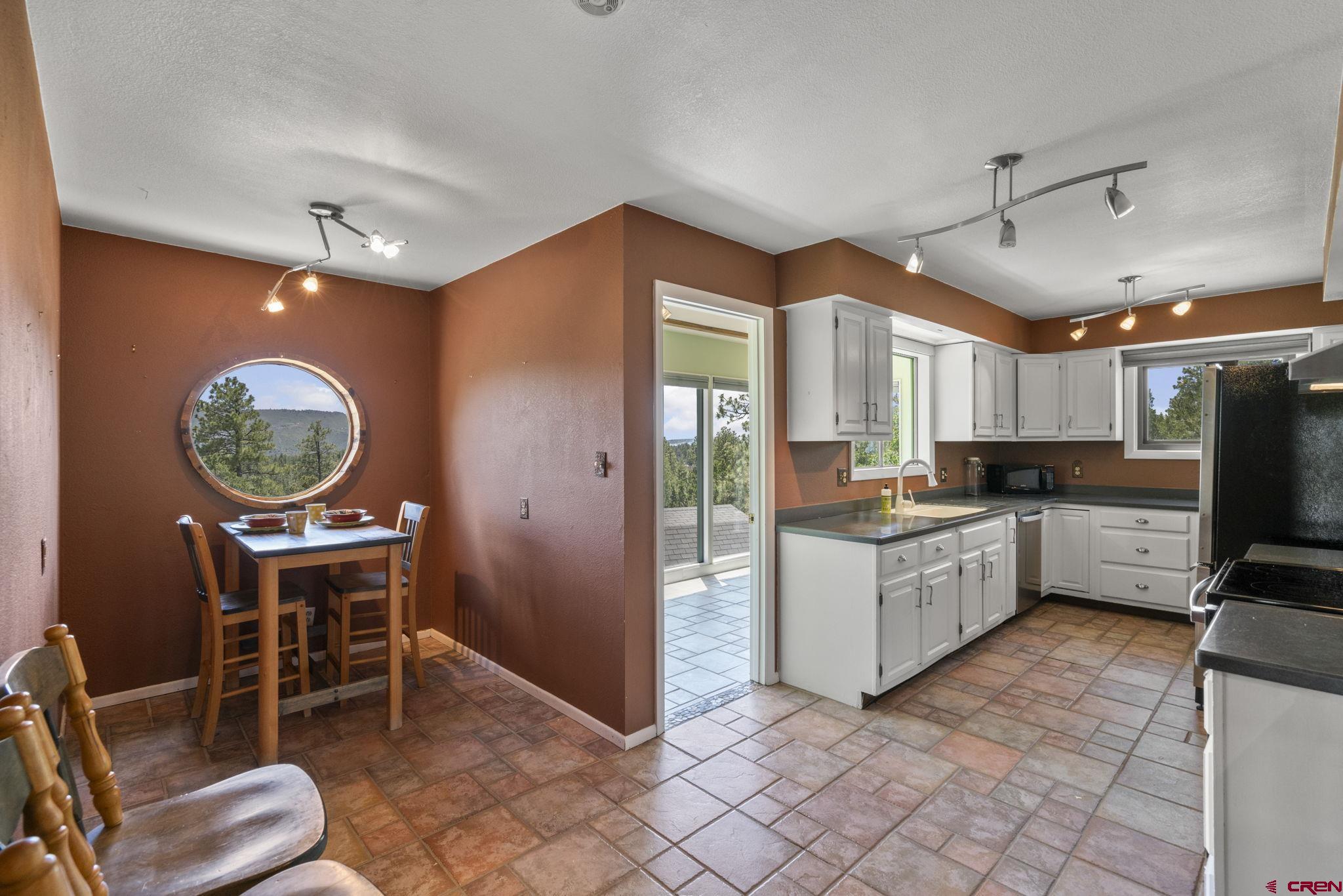 150 Pine Road Durango, CO 81303 - Photo 8 of 35 a kitchen with cabinets and chairs