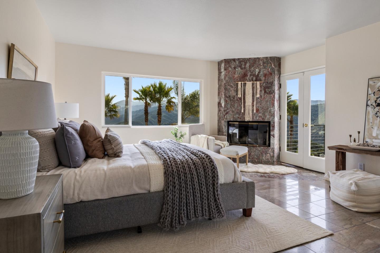 320 El Caminito Road Carmel Valley, CA 93924 - Photo 25 of 62 a living room with a bed furniture large mirror and a large window