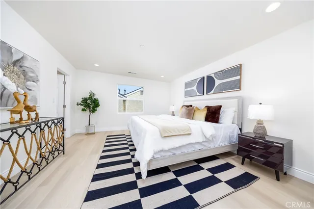 a bedroom with furniture and a painting on the wall