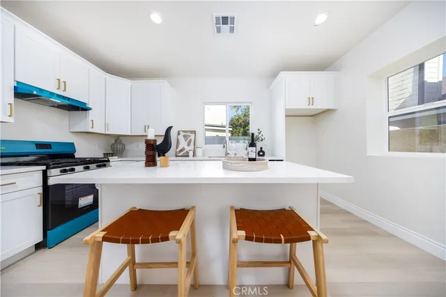 a kitchen with stainless steel appliances a sink and a stove