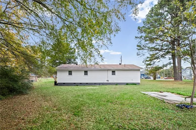 a white house that has a tree in front of it