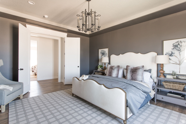 1378 North 1500 West, Unit 8 Mapleton, UT 84664 - Photo 16 of 20 Spacious bedroom featuring wood-finish flooring, a contemporary chandelier, and a wide entryway with double doors