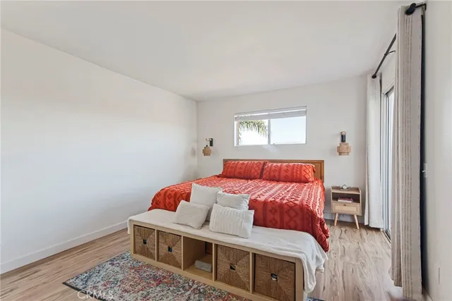 a bedroom with a large bed and a potted plant