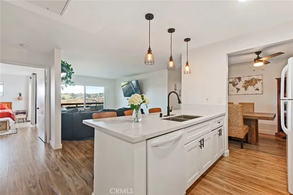a kitchen with stainless steel appliances a sink stove and cabinets
