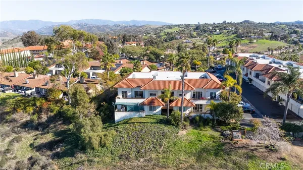 an aerial view of a house with a yard and garden