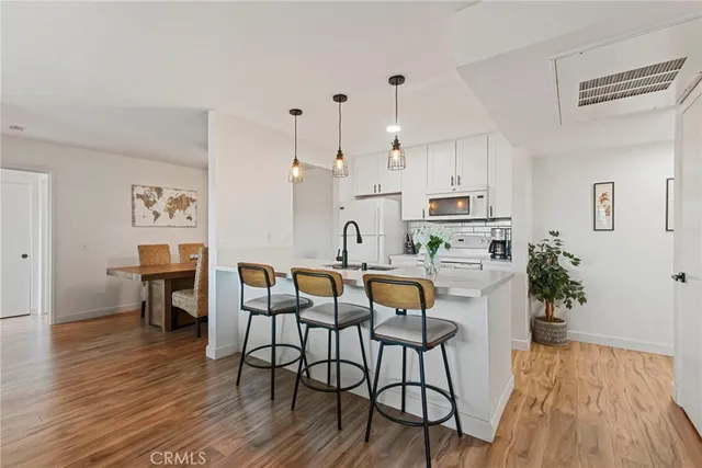 a kitchen with stainless steel appliances granite countertop a sink and a refrigerator