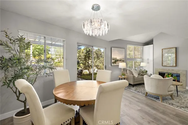a living room with furniture a chandelier and a large window