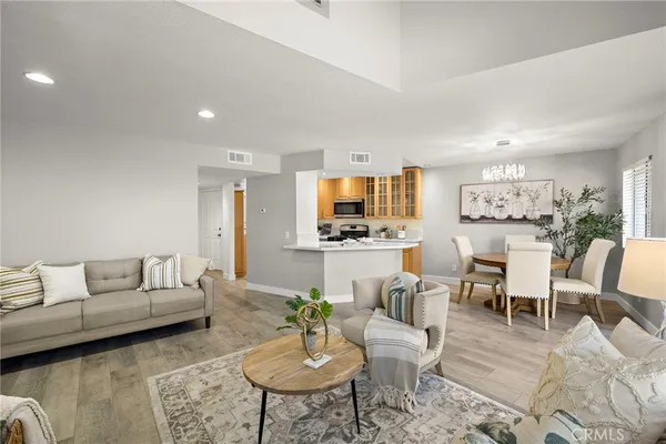 a living room with furniture kitchen view and a table