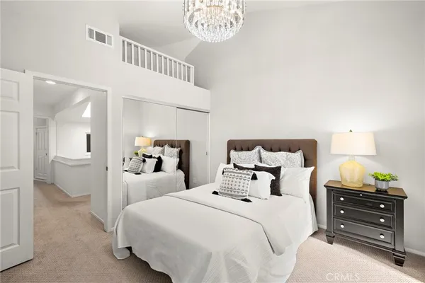 a bedroom with bed and a large mirror