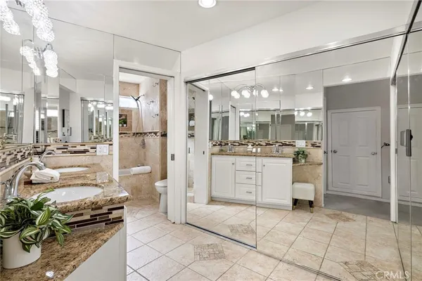 a kitchen with stainless steel appliances kitchen island granite countertop a refrigerator and a stove top oven