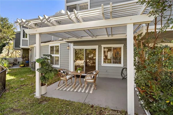 a view of a house with backyard and sitting area