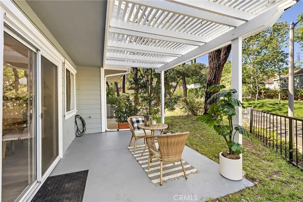 a view of a porch with chairs and backyard