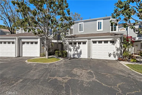 a front view of a house with a yard and a garage