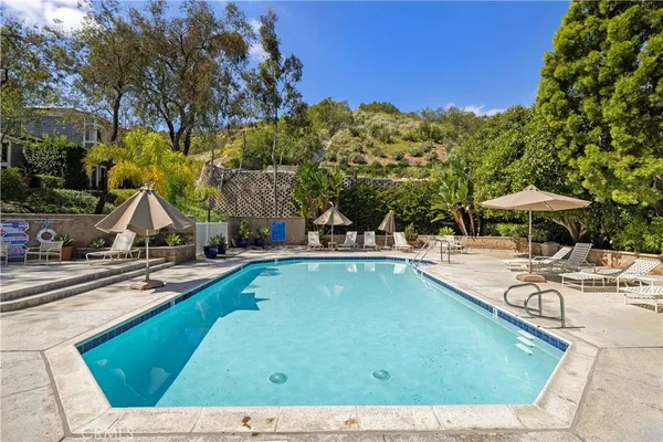 a view of a swimming pool with an outdoor space and seating area