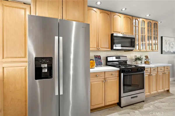 a kitchen with stainless steel appliances a refrigerator stove and microwave