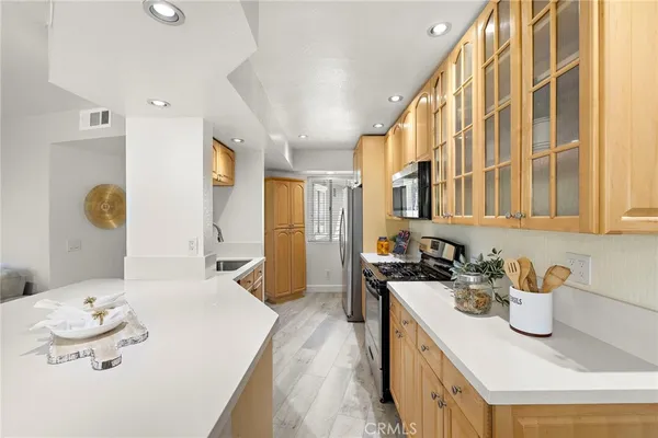 a kitchen with a sink stove and refrigerator