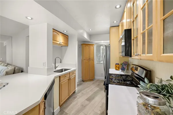 a kitchen with a sink stove top oven and cabinets